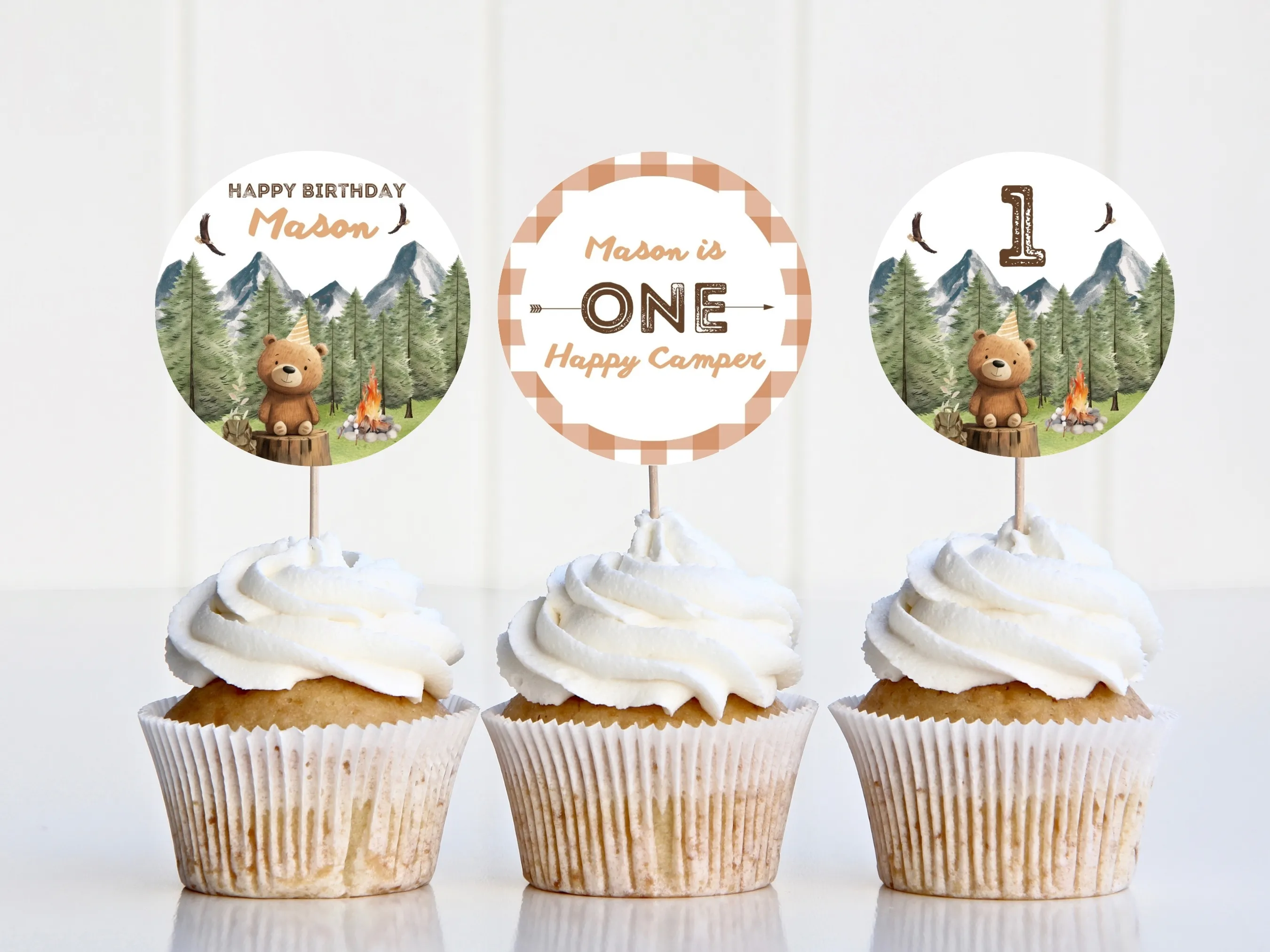 One Happy Camper cupcake toppers with camping and woodland theme and matching “One” cake topper for 1st birthdays, editable Canva template by fllcdesigns