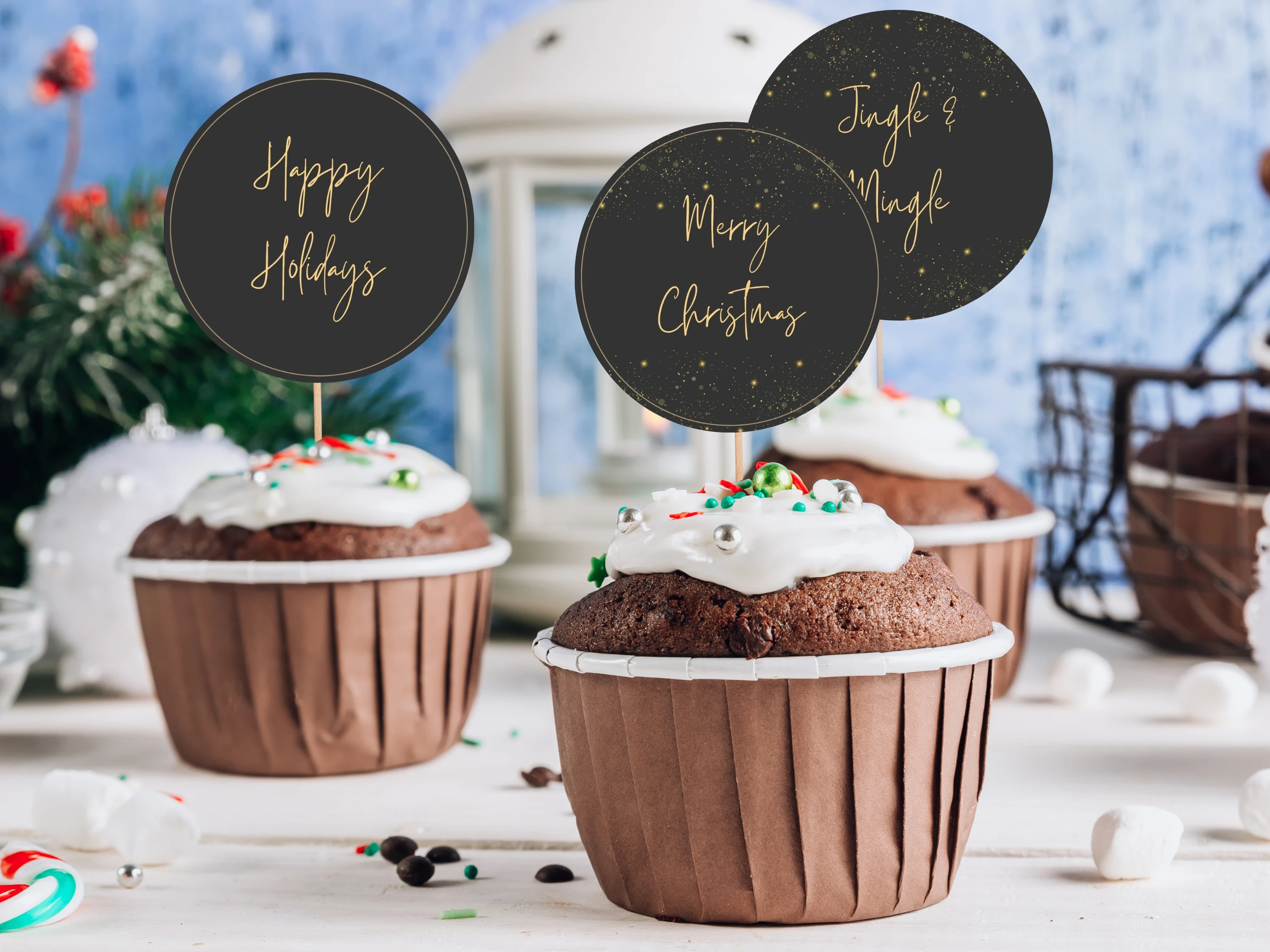 Black and Gold Christmas cupcake toppers displayed on festive cupcakes with Merry Christmas, Happy Holidays and Jingle & Mingle sayings in elegant gold typography on round black designs.