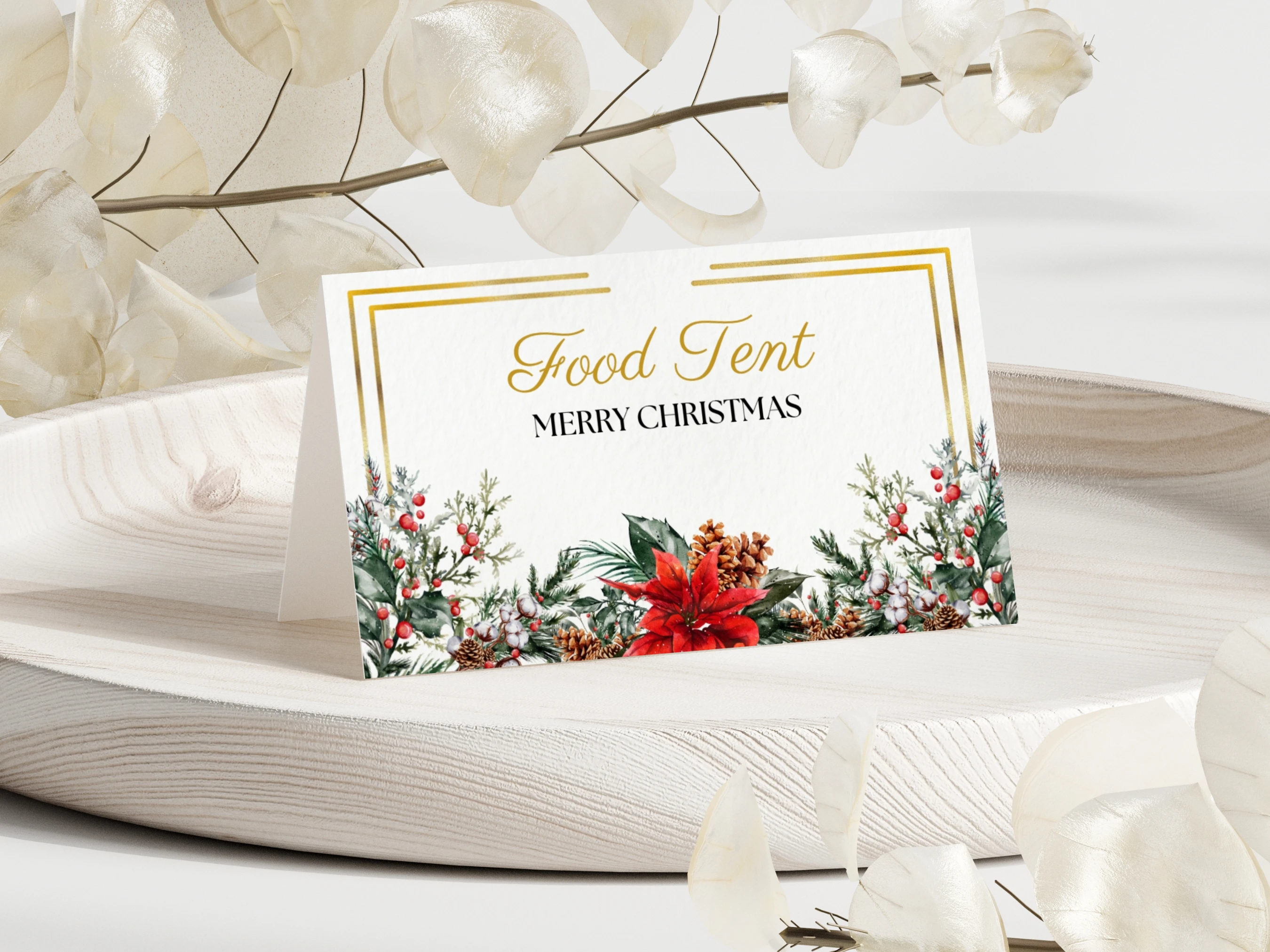 Folded Christmas place card and food label with golden frame, evergreen branches, red berries, pinecones, poinsettia and editable text